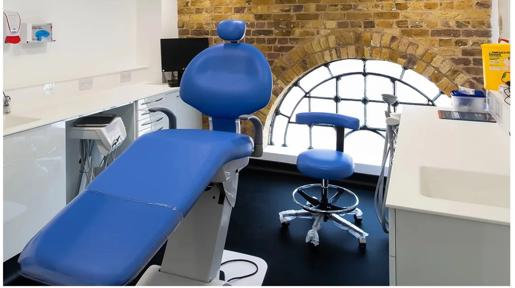 Inside our Brentford practice — a modern treatment room with an arched brick window